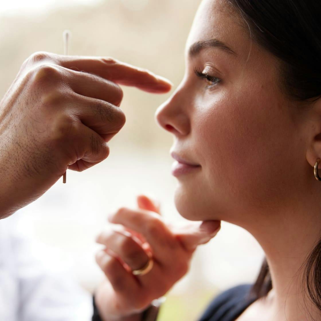 Seattle Plastic Surgeon, Dr. Egari examining patient's nose