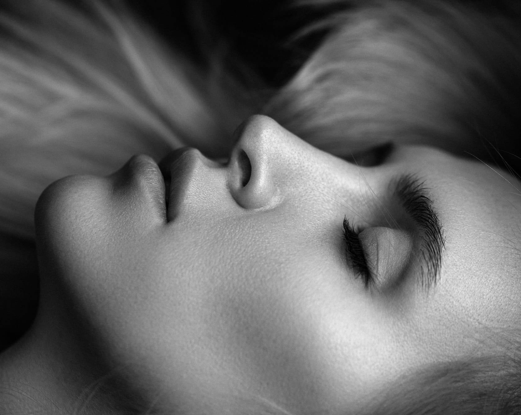 black and white image of the side of a woman's face