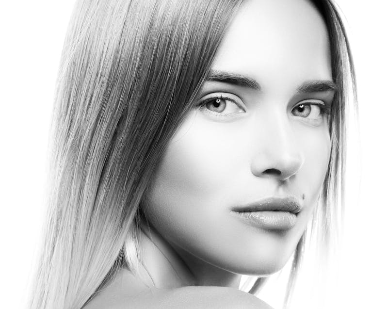 a black and white image of a close up of a woman's face