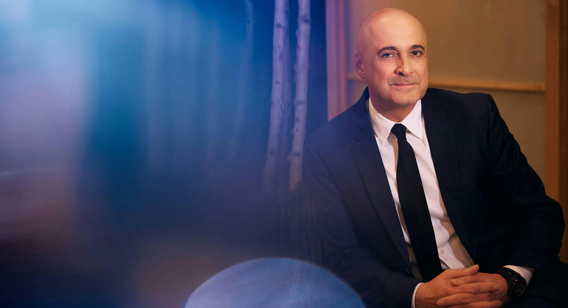 an banner image of Dr. Egrari leaning in a chair