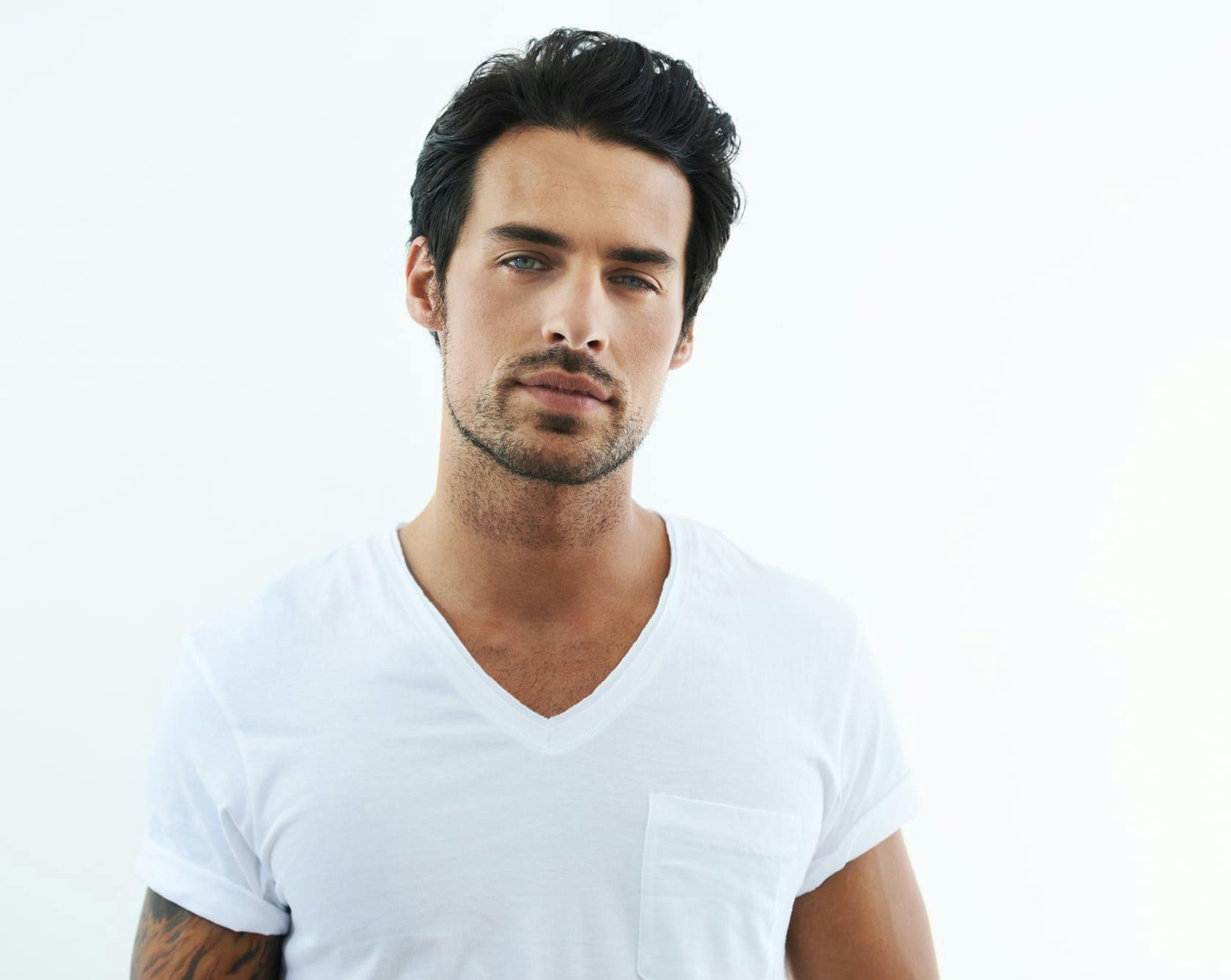 man with black hair wearing a white shirt