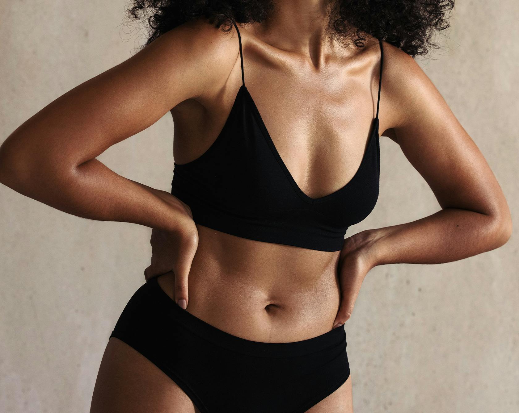 an image of a woman in a black top and underwear