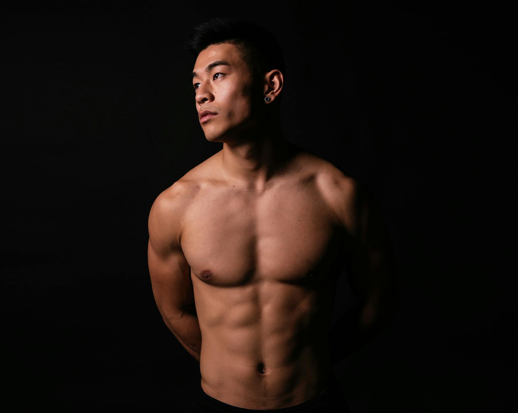 an image of a man without a shirt looking off to the site