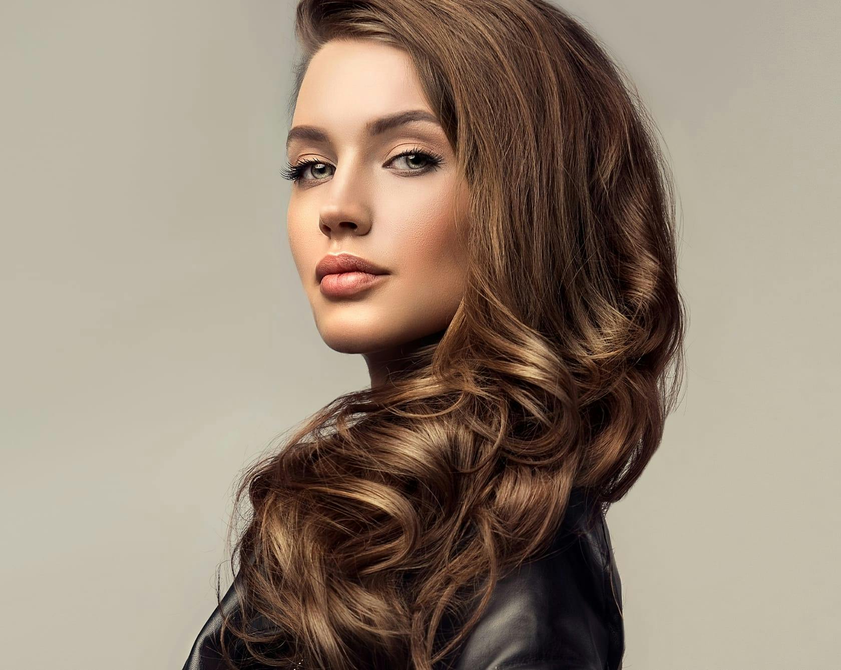 an image of a woman with brunette hair in a black top
