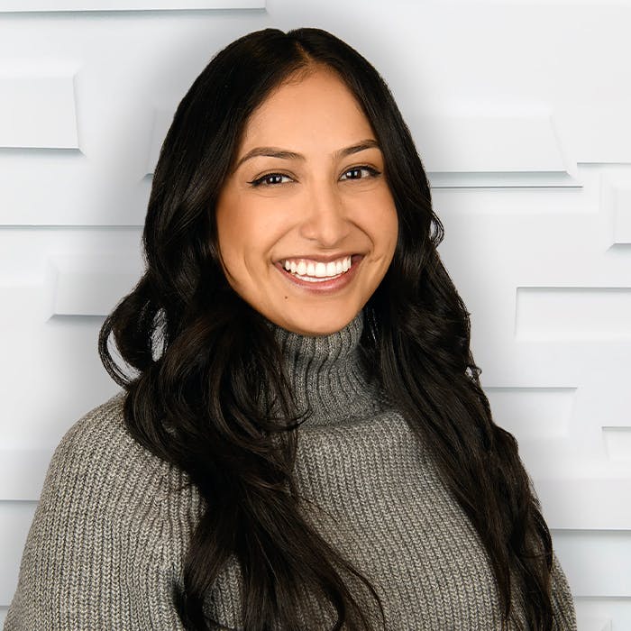 woman with dark hair in a grey turtleneck