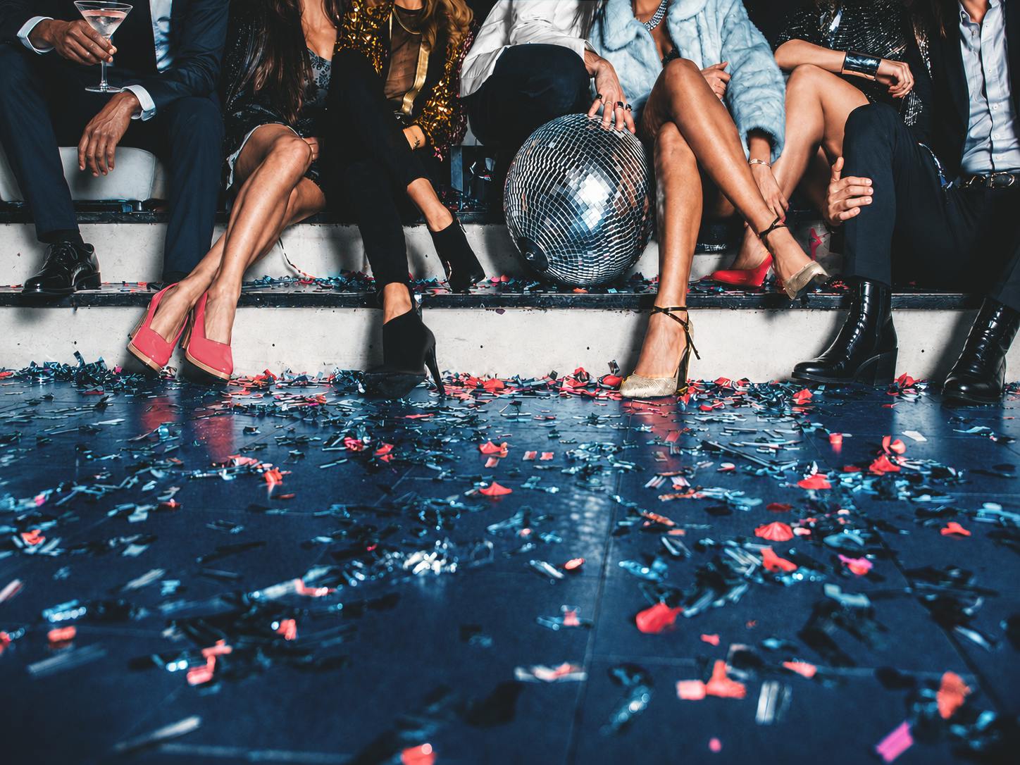 women sitting on stairs at a party
