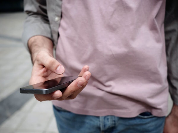 Image of a man holding a phone Treyd