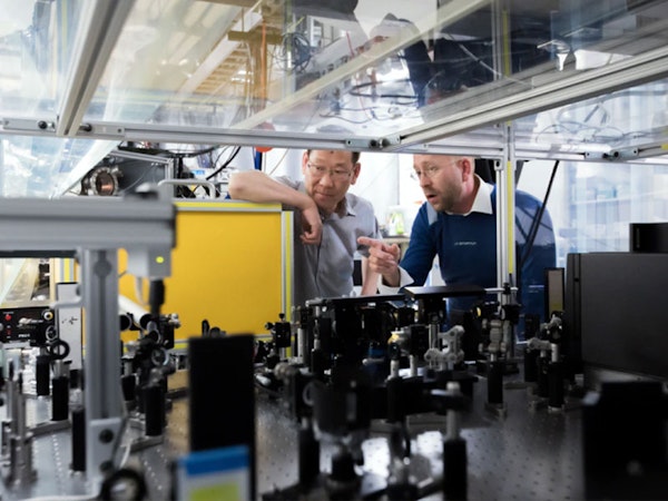 Image of two men working in a factory