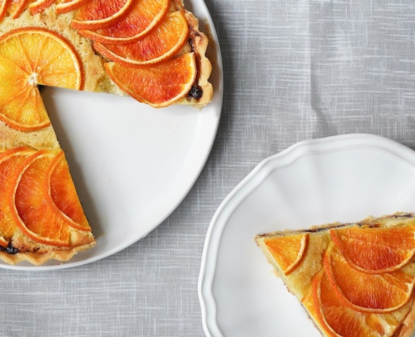 A slice of pie being taken from a whole pie