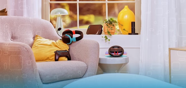 black gaming accessories with colorful details, laid out nicely on an armchair in a bright modern room