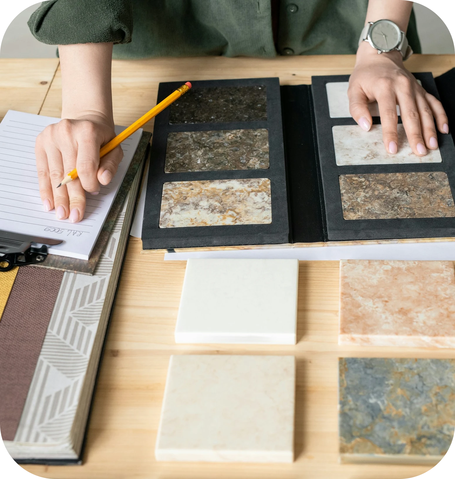 hands looking at stones on desk