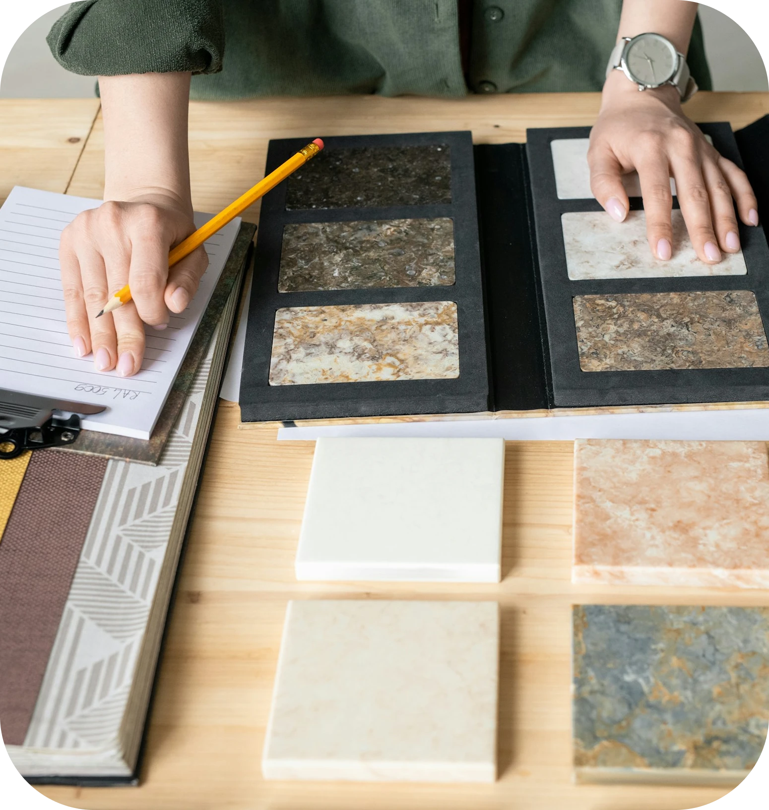 hands looking at stones on desk