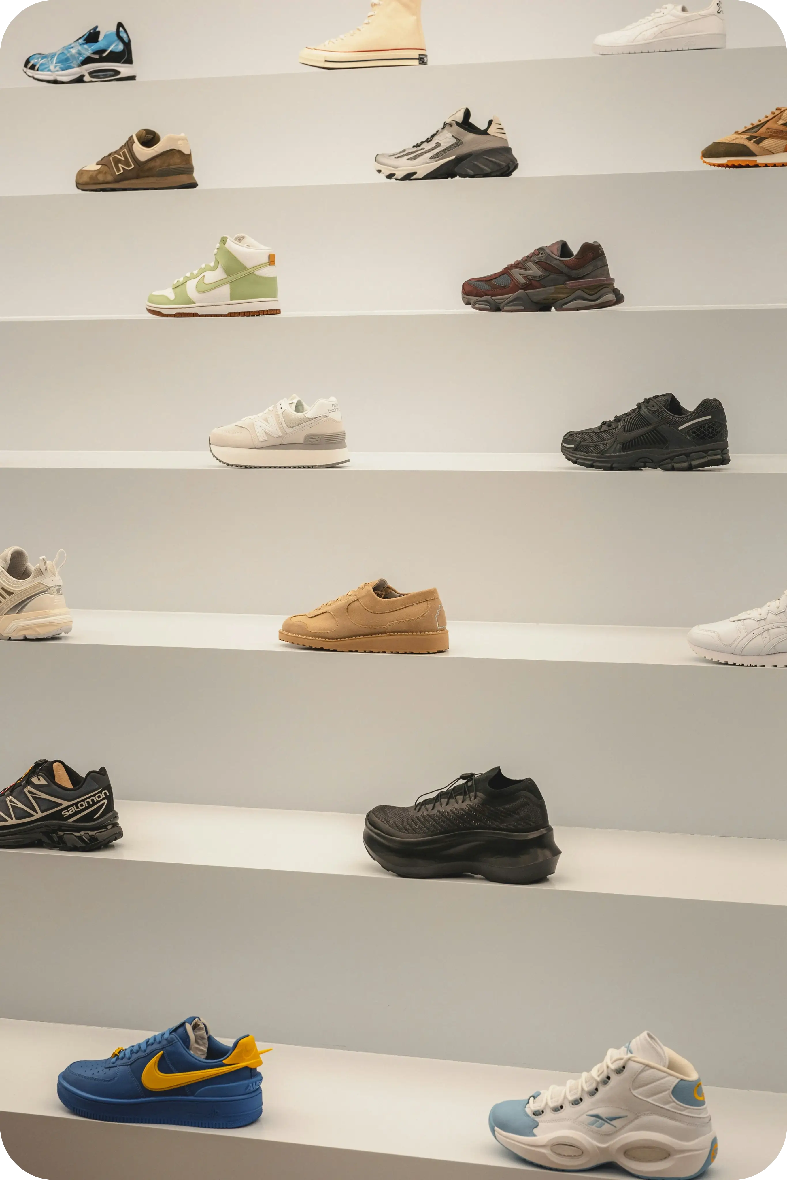 sports shoes on white shelves