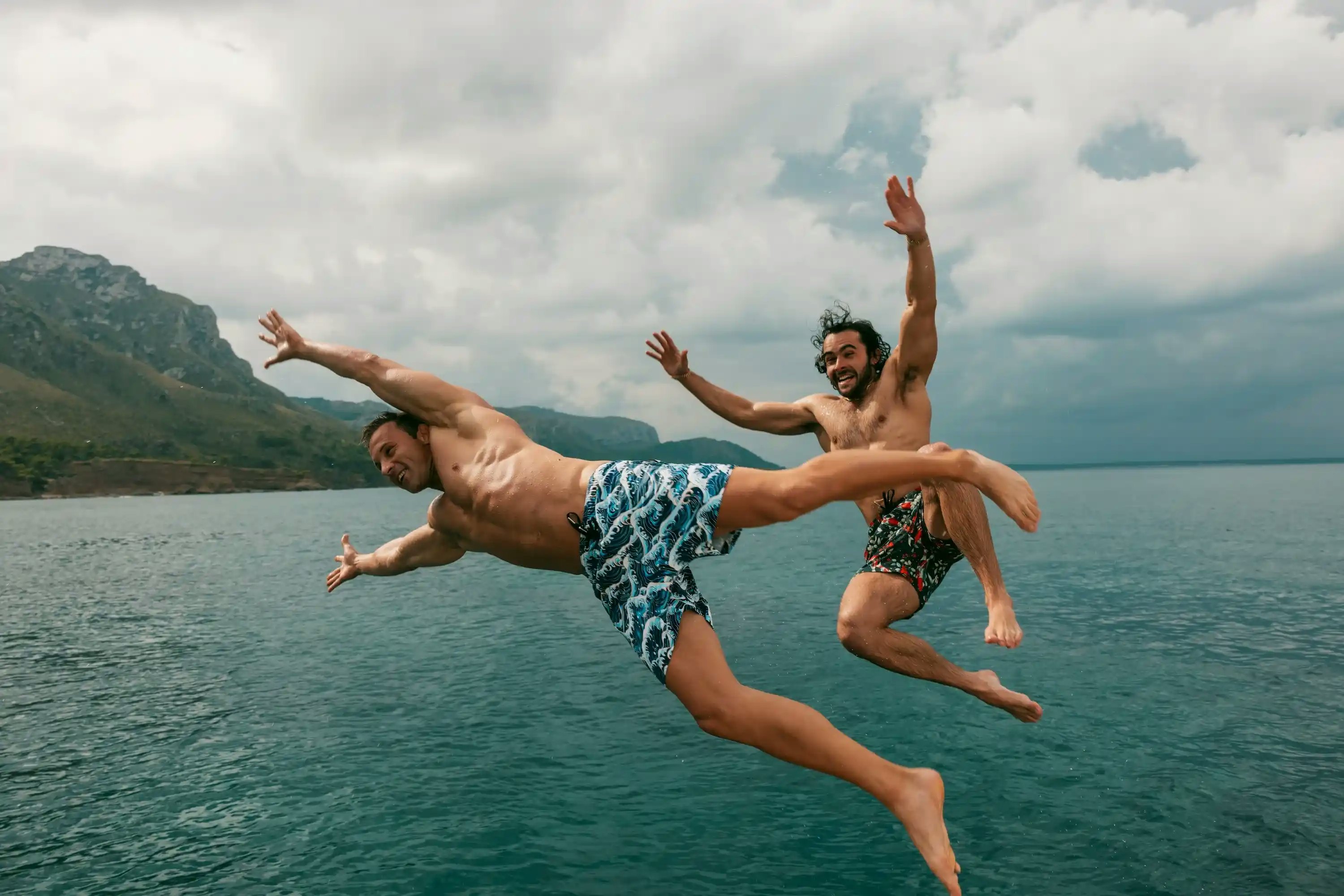 Two men with colorful swim shorts from Swole Panda