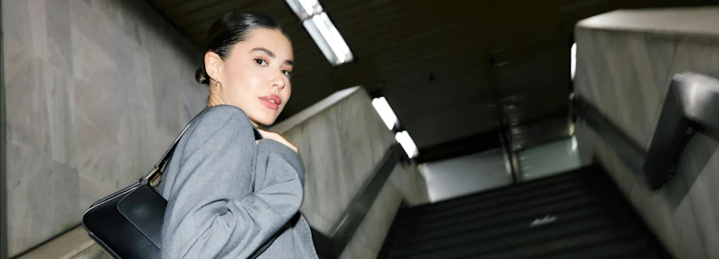 Person walking up the stairs looking back at the camera.webp