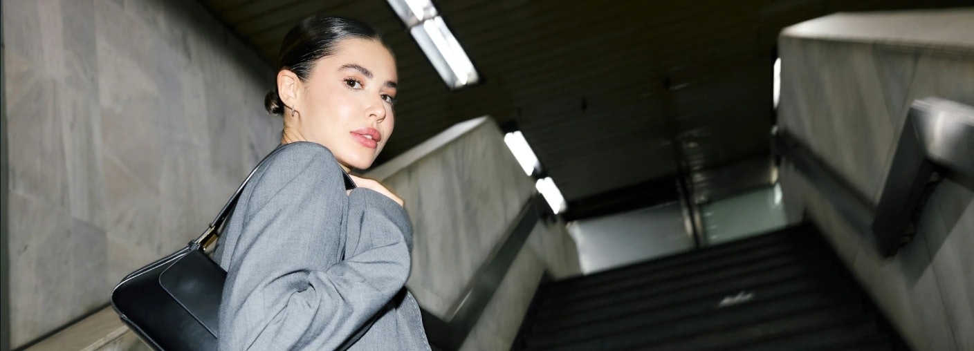 Person walking up the stairs looking back at the camera.webp