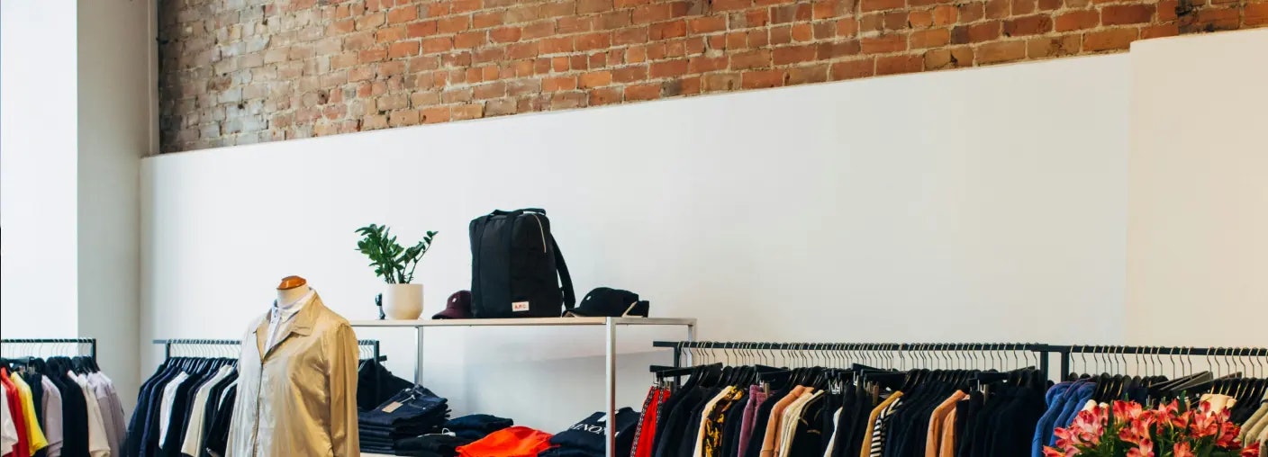 Overtrading article cover image featuring an apparel shop with brick wall and white panel