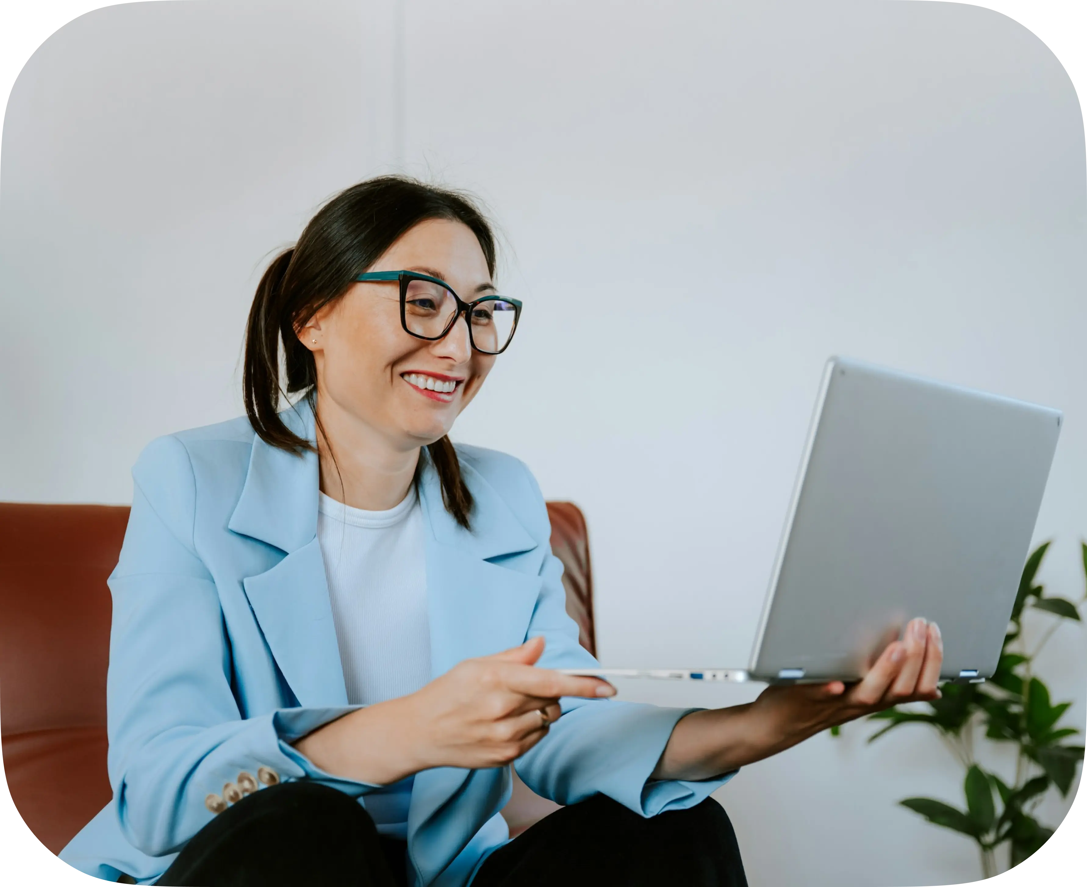 A person smiling while using a laptop