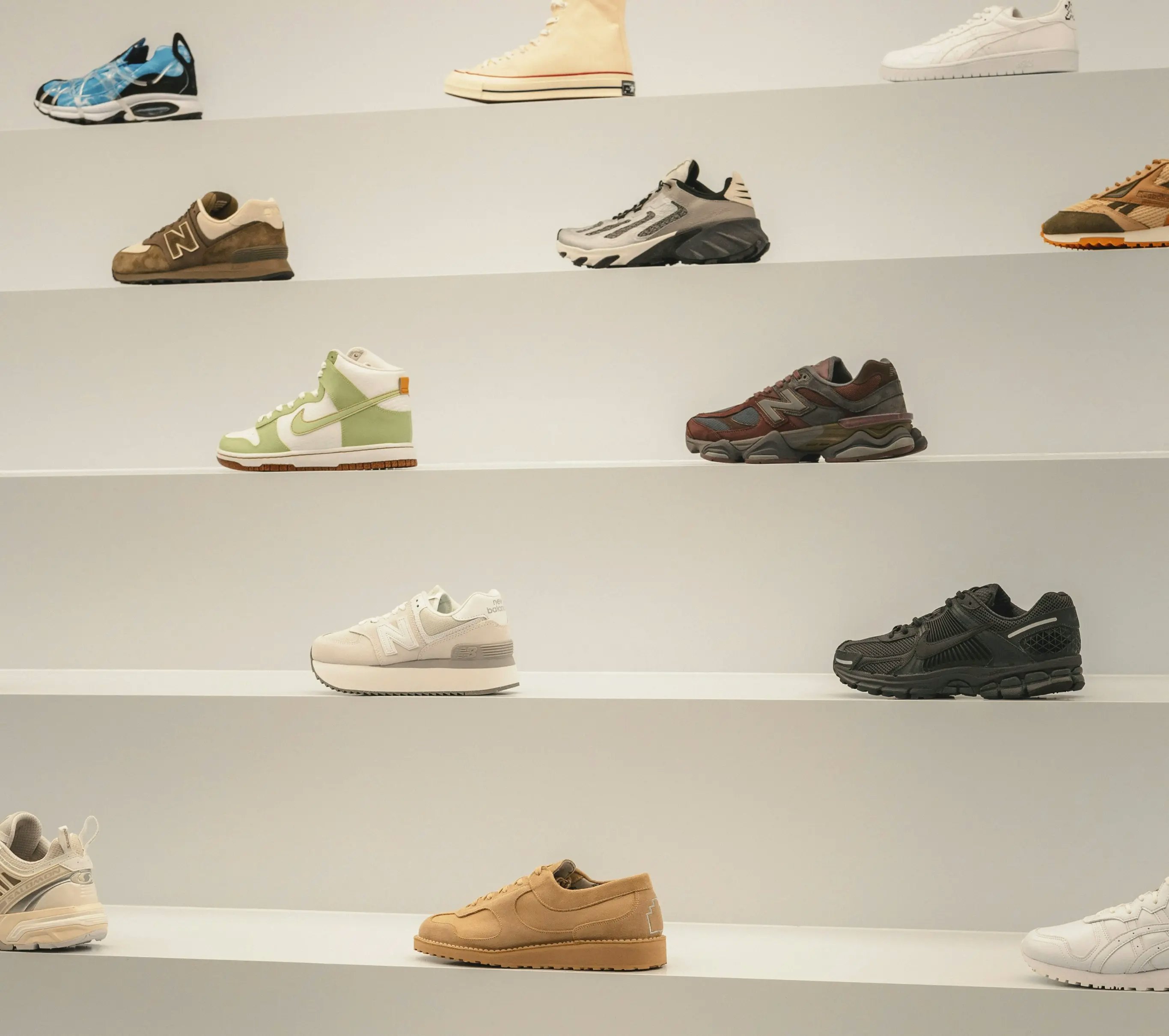Sneakers lined up on white shelves