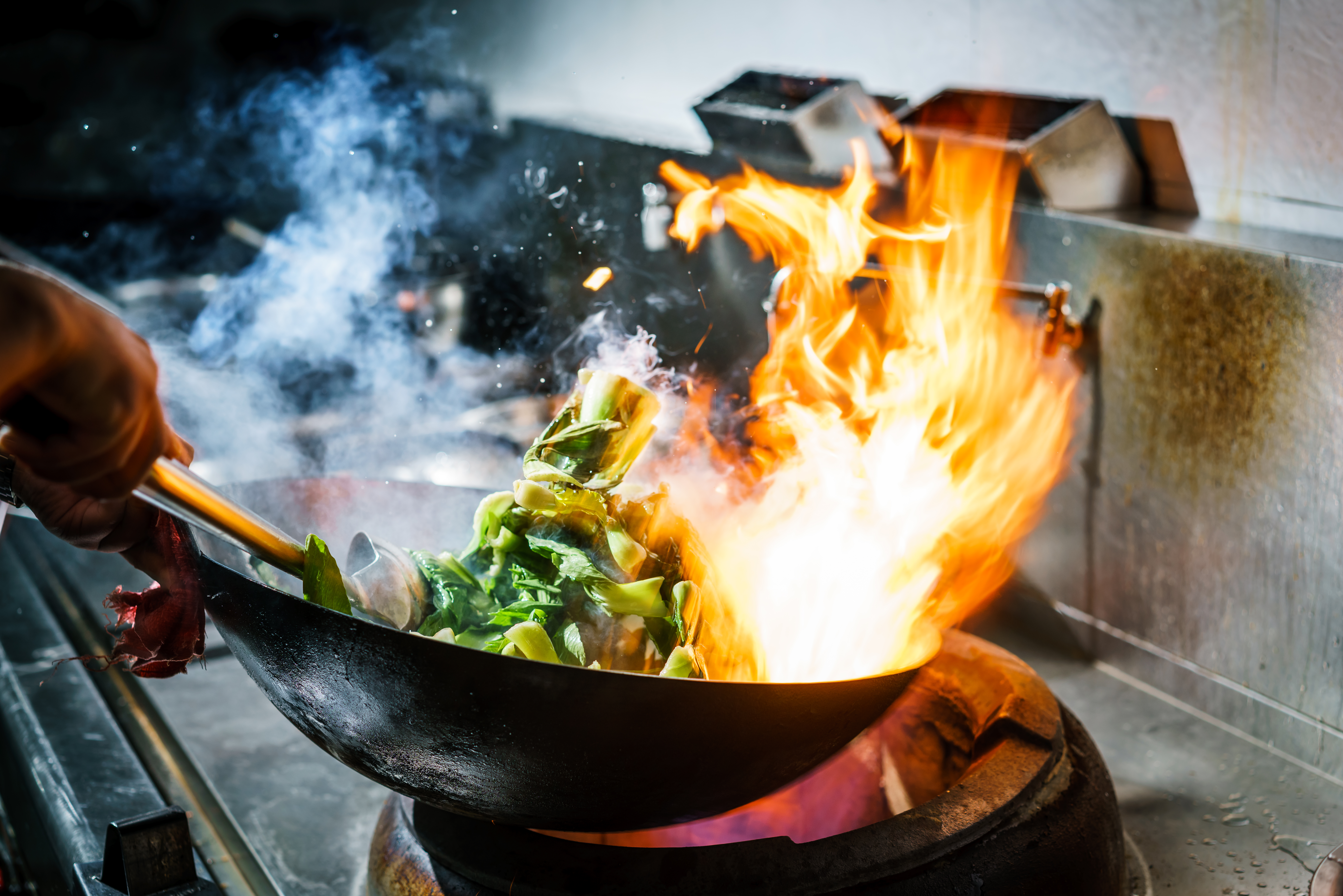 Vegetables being stir fried in a wok