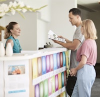 Two people making enquiry to a staff over the desk