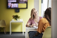 Students talking at a desk