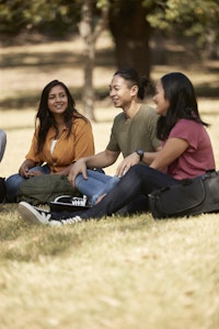 students sitting in park