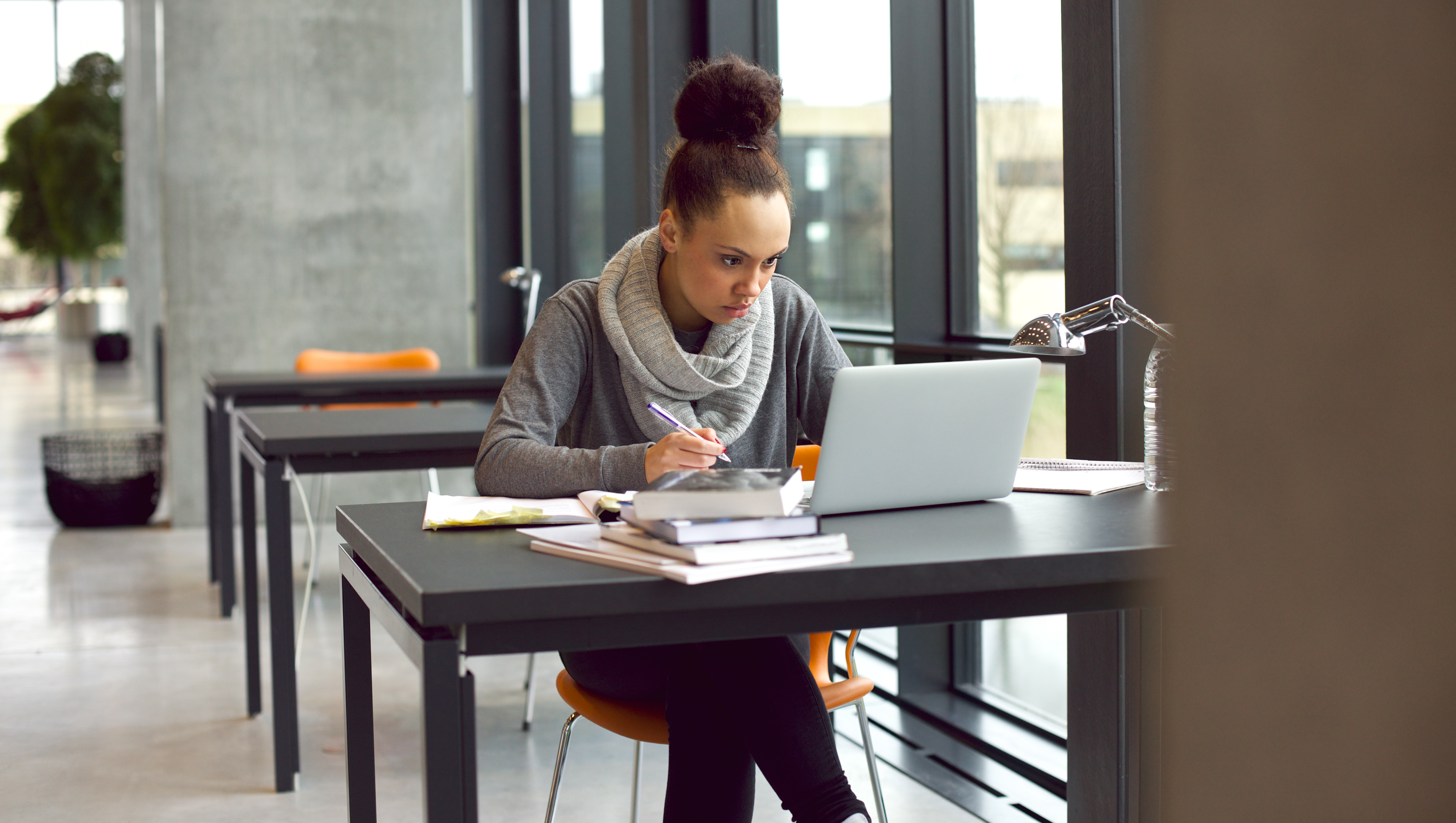 School age student studying using laptop