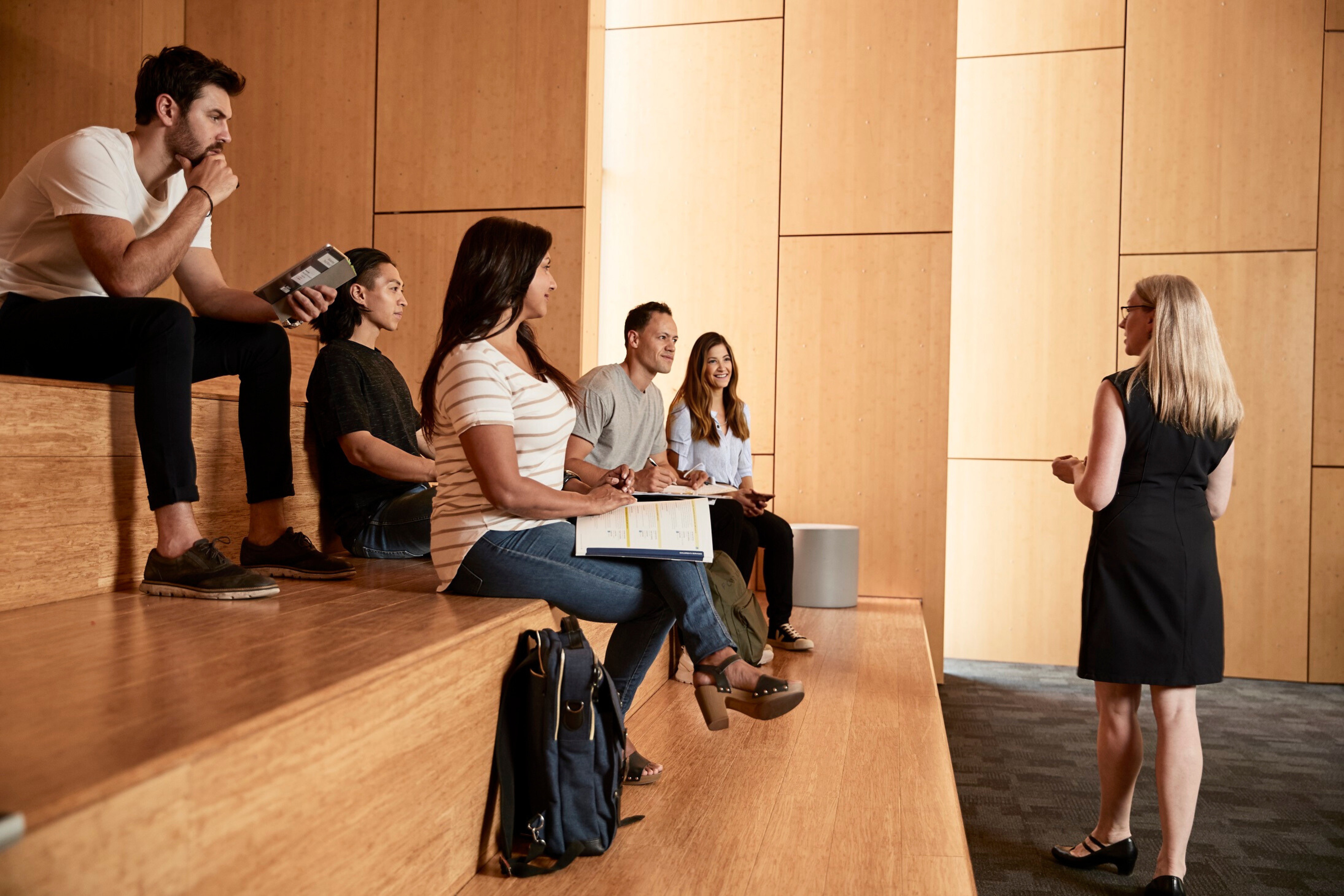 instructor speaking to students in hall