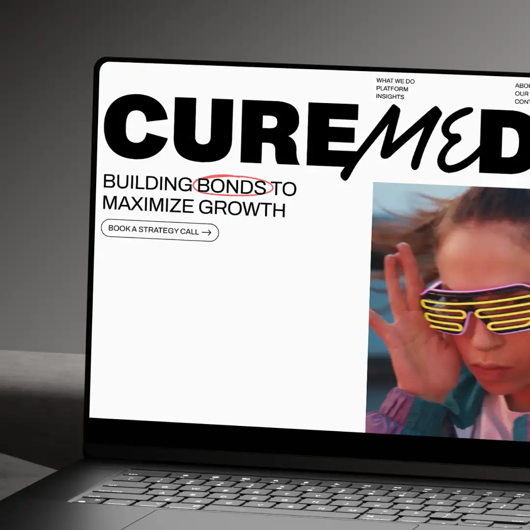 CureMedia’s website displayed on a laptop, featuring the message “Building bonds to maximize growth” and campaign imagery.