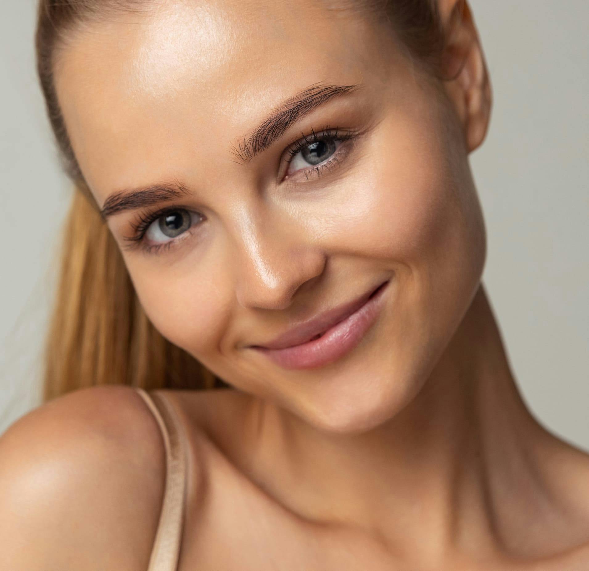 Woman with Hair up and Smiling at the Camera