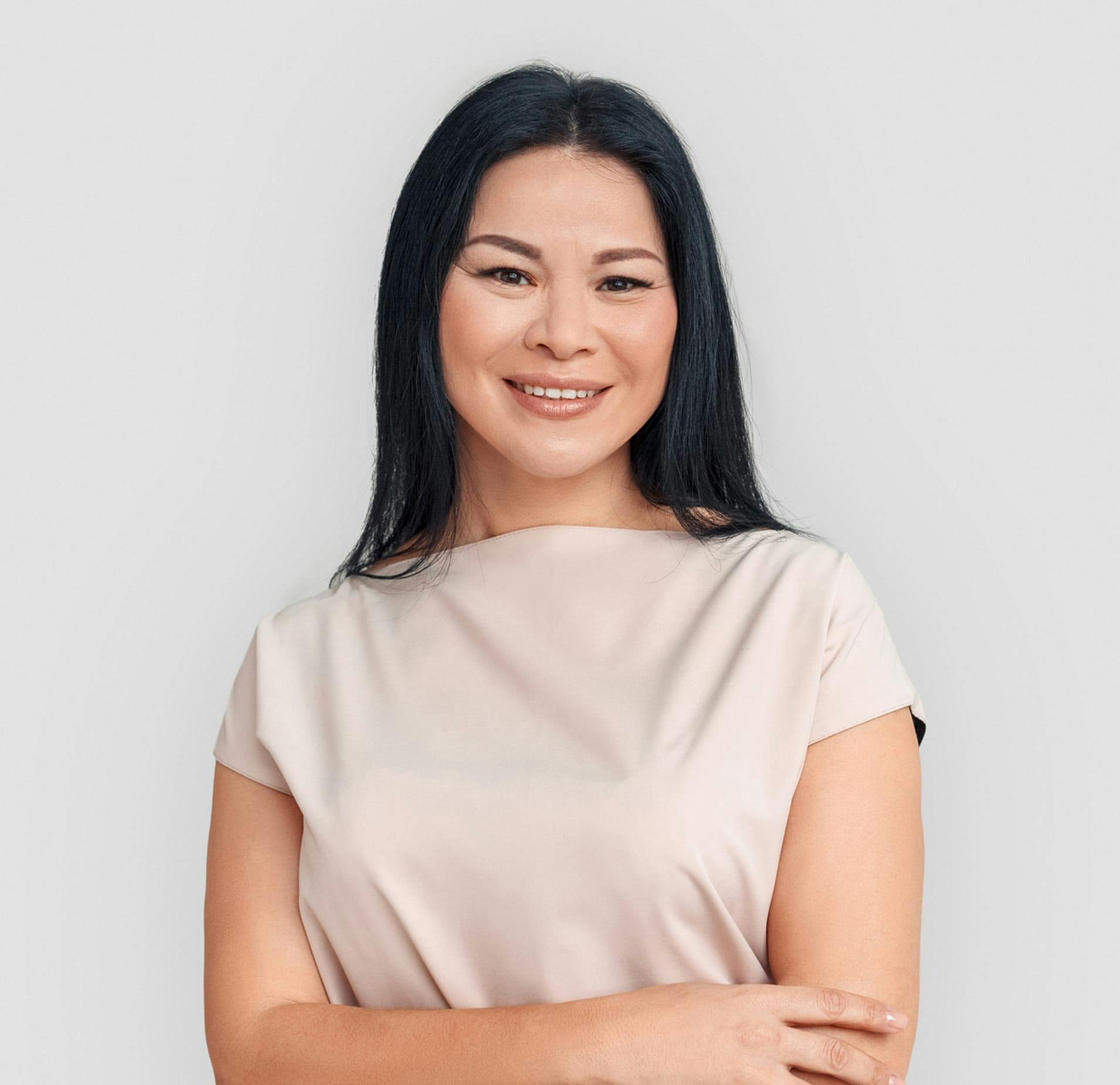 Woman with Beige Blouse and Arms Crossed