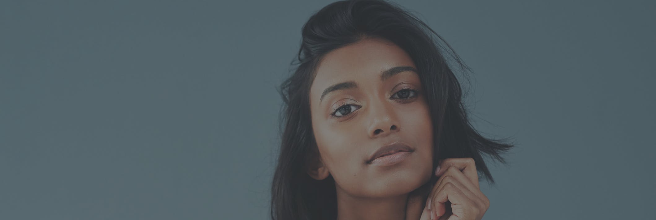 Ethinic woman looks longingly at camera in studio shoot. Her facial features are to show the potential results of a ethnic rhinoplasty in Redondo or Manhattan Beach