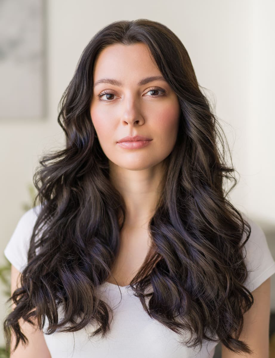Woman with long brown curly hair