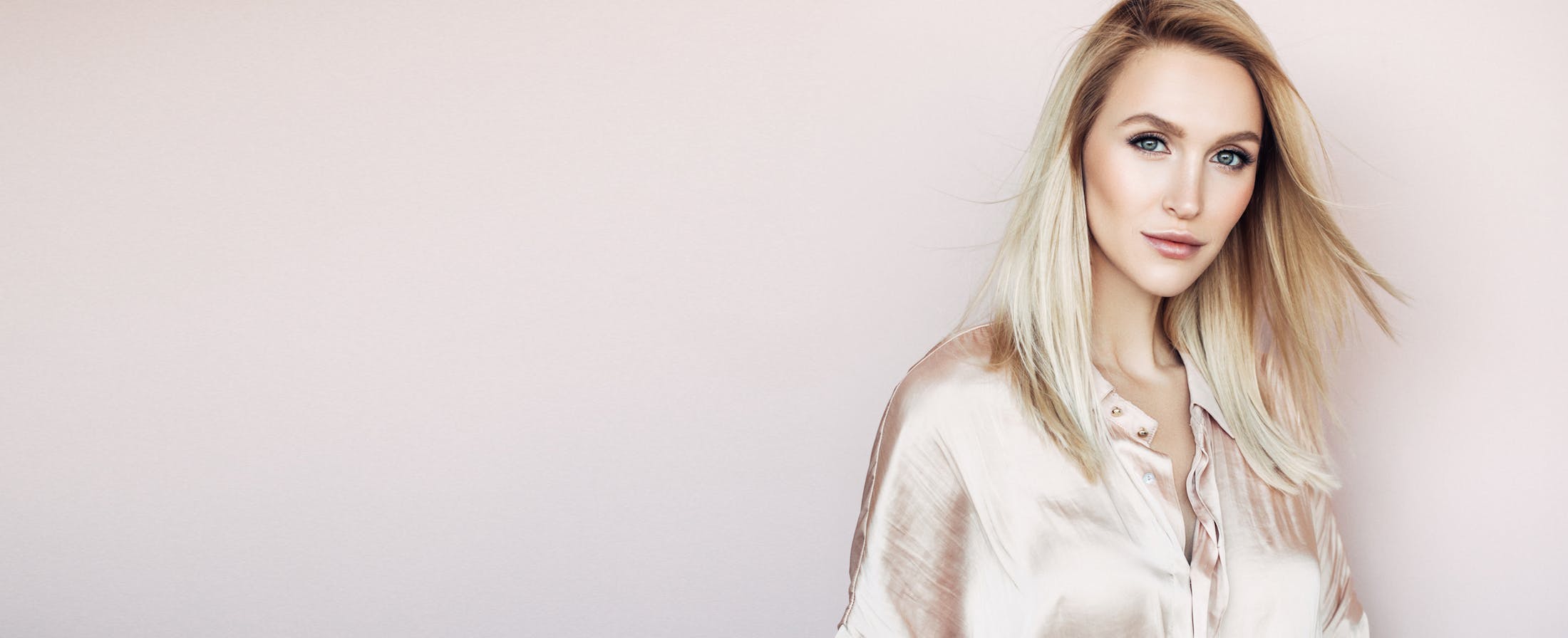 Pretty Blonde Woman with Pink Blouse and Background