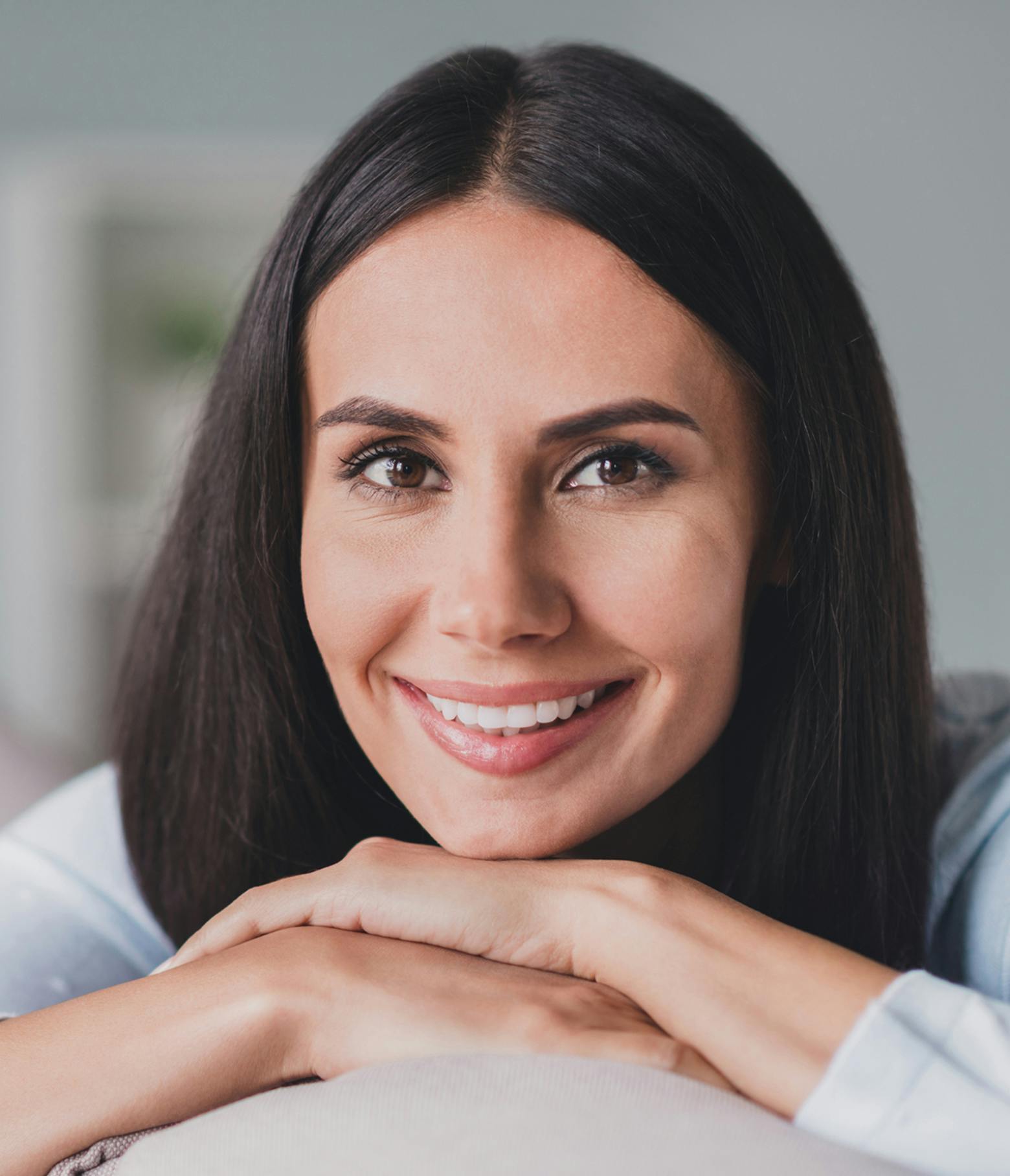 Woman with Dark Hair Resting her Face on her Hands