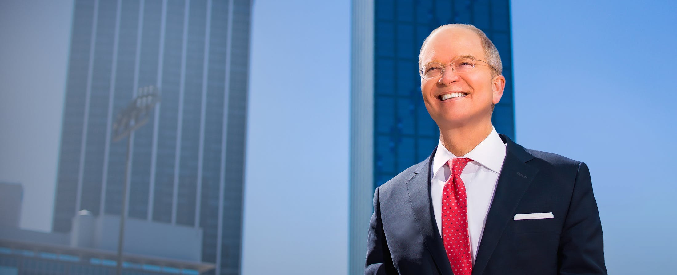 Dr. Pruitt Smiling with Tall Buildings in the Background
