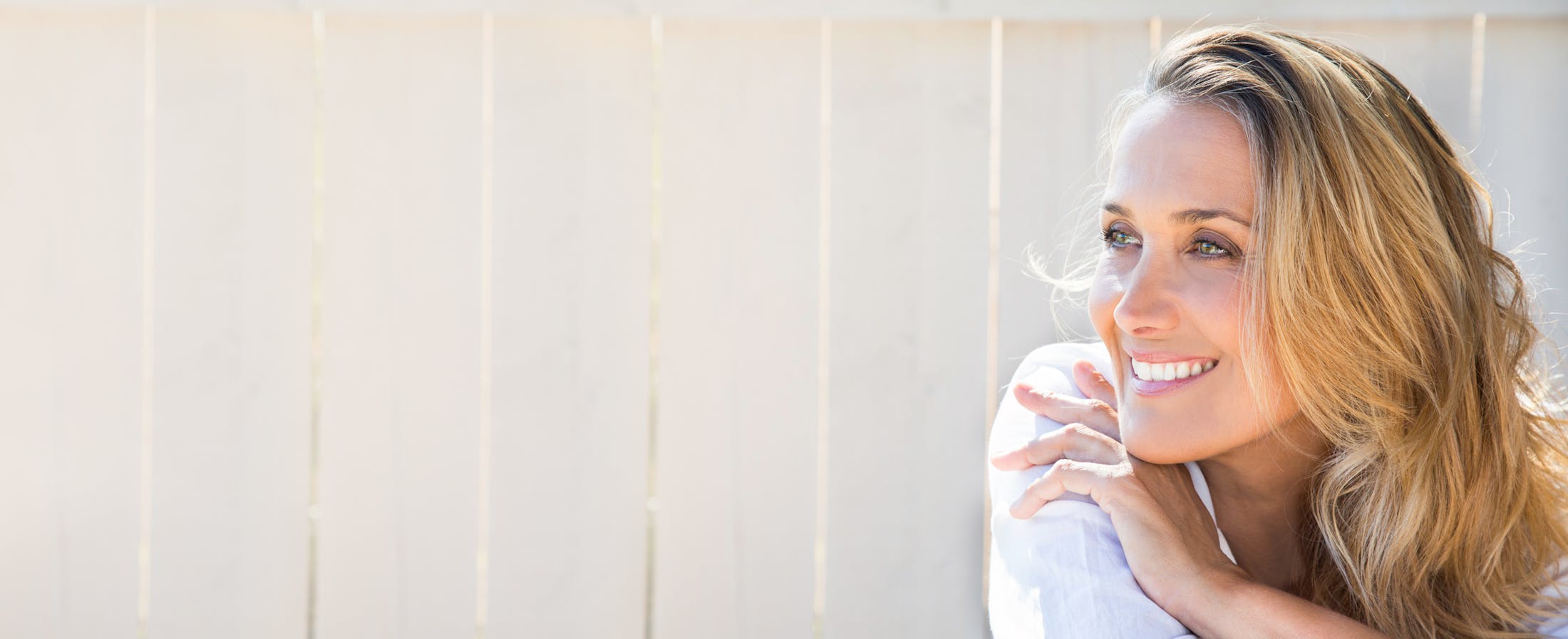 Smiling Woman Leaning with Her Arms Crossed