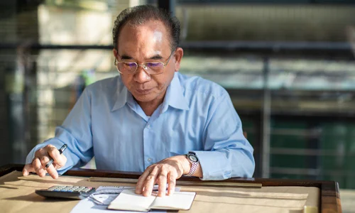 Older man calculating medical costs