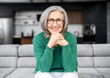 Older woman with glasses smiling