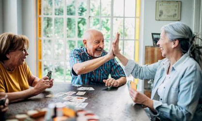 Older man and women playing poker