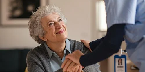 Woman in assisted living or nursing home receiving support
