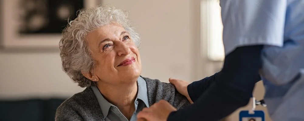 Woman in assisted living or nursing home receiving support
