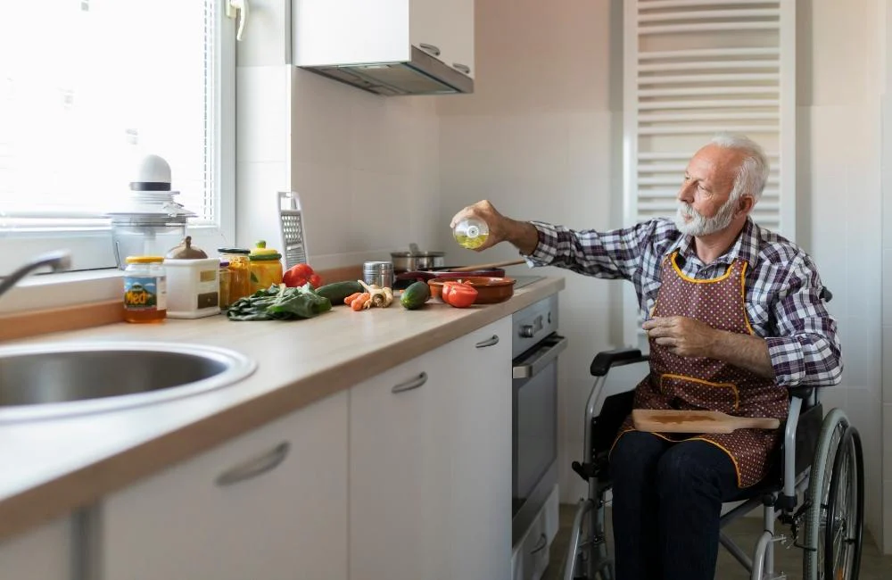 Older man in kitchen with wheelchair modifications