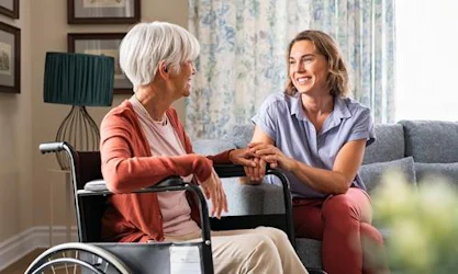 Senior and caregiver in senior living facility