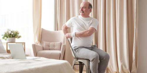 Senior man doing seated exercise