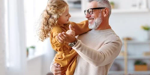 grandfather dancing with granddaughter