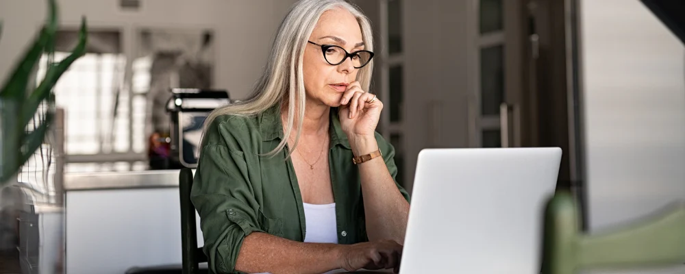 older woman researching on computer