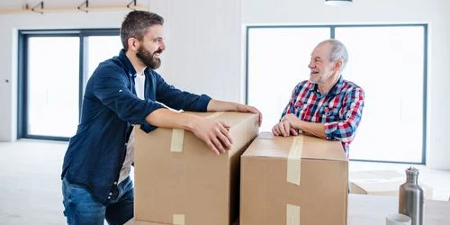 Older man getting assistance with moving