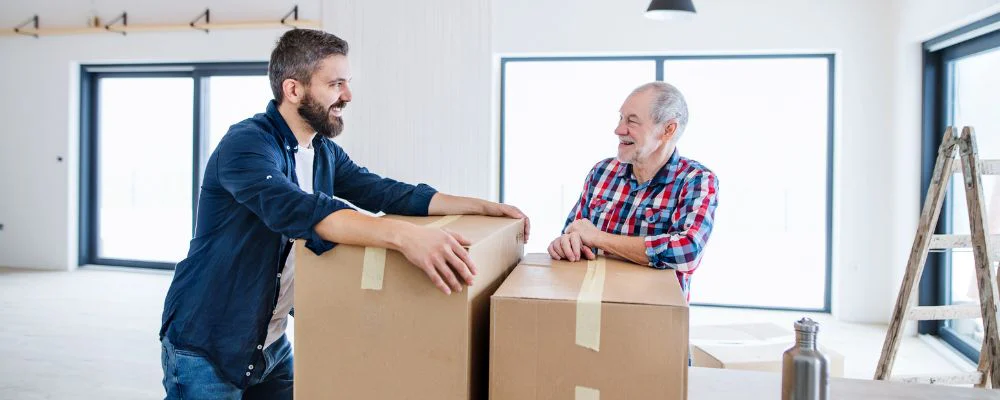 Older man getting assistance with moving hero